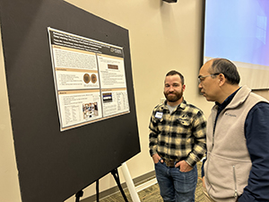 Charlie Warner and Songlin Fei discussing Charlie's poster at the HTIRC Annual Meeting.